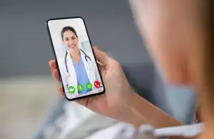 Person Videochatting With Doctor On Mobile Phone